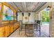 Charming outdoor bar area with rustic barrel table, perfect for entertaining at 516 Kumquat Dr, Anna Maria, FL 34216
