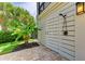 Outdoor shower with a tropical plant and brick flooring near the outdoor shower at 516 Kumquat Dr, Anna Maria, FL 34216