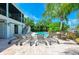 Backyard with a pool, palm trees, lounge chairs, and brick pavers at 516 Kumquat Dr, Anna Maria, FL 34216