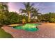 Backyard with the pool is beautifully landscaped and surrounded by brick pavers at 516 Kumquat Dr, Anna Maria, FL 34216
