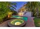 Inviting backyard oasis featuring a pool, spa, lush tropical landscaping, and a multi-story home with balconies at 516 Kumquat Dr, Anna Maria, FL 34216
