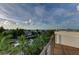 Roof deck with railings shows waterfront views of neighborhood at 516 Kumquat Dr, Anna Maria, FL 34216