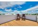 Roof deck with two chairs and wood-like flooring shows blue skies and beautiful clouds at 516 Kumquat Dr, Anna Maria, FL 34216