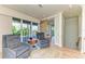 Cozy sitting area with sliding doors to balcony, features comfortable chairs and stylish lighting at 516 Kumquat Dr, Anna Maria, FL 34216