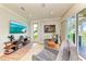 Sitting room with outdoor views, TV, and modern shelving at 516 Kumquat Dr, Anna Maria, FL 34216