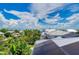 Aerial view of solar panels on roof and views of boats in canals and lush landscaping at 516 Kumquat Dr, Anna Maria, FL 34216