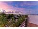 Waterfront home with stunning views of the canal and colorful sunset sky from the balcony at 516 Kumquat Dr, Anna Maria, FL 34216