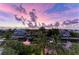 Beautiful waterfront homes with lush palm trees and gorgeous sunset reflected in the canal at 516 Kumquat Dr, Anna Maria, FL 34216
