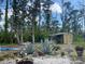 Expansive backyard features mature trees, statues, a shed, and a whimsical garden at 5180 Guava Ter, Port Charlotte, FL 33981