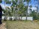Relaxing backyard with a water fountain, a hammock and lush trees for shade at 5180 Guava Ter, Port Charlotte, FL 33981