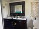 Stylish bathroom with a double vanity, framed mirror, and seashell décor at 5180 Guava Ter, Port Charlotte, FL 33981