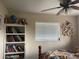 A cozy bedroom with a bookshelf, a window, a colorful bed and wall decor at 5180 Guava Ter, Port Charlotte, FL 33981