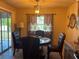 Bright dining room features a round table and views of the screened in patio at 5180 Guava Ter, Port Charlotte, FL 33981