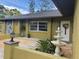 Inviting entrance showcasing a decorative fountain, tasteful landscaping, and modern exterior lighting at 5180 Guava Ter, Port Charlotte, FL 33981