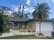 Charming single-story home featuring lush landscaping, a fountain, and a two-car garage at 5180 Guava Ter, Port Charlotte, FL 33981