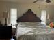 Comfortable bedroom with hardwood floors, ceiling fan, and natural light from two windows at 5180 Guava Ter, Port Charlotte, FL 33981