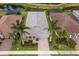 Aerial view of a well-maintained home featuring palm trees and lush landscaping, nestled in a desirable neighborhood at 5557 Long Shore Loop, Sarasota, FL 34238