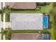Bird's-eye view of a home featuring a pristine roof, lush landscaping, and a private screened-in pool at 5557 Long Shore Loop, Sarasota, FL 34238