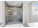 Modern bathroom featuring a glass shower, neutral tile, and double vanity at 5557 Long Shore Loop, Sarasota, FL 34238