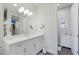 Bright bathroom with modern vanity, featuring a large mirror and a separate water closet at 5557 Long Shore Loop, Sarasota, FL 34238