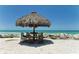 Beach Tiki table, with sandy white beach and clear blue water views for outdoor enjoyment at 5557 Long Shore Loop, Sarasota, FL 34238