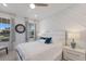 Bright bedroom with vaulted ceiling, a large decorative clock, and stylish decor for a relaxing retreat at 5557 Long Shore Loop, Sarasota, FL 34238