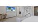 Well-lit bedroom featuring a vanity desk with an illuminated mirror and a large television at 5557 Long Shore Loop, Sarasota, FL 34238