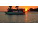 Sunset dinner cruise on the water with a clear sky for a romantic evening of seaside relaxation at 5557 Long Shore Loop, Sarasota, FL 34238