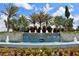 Community entrance to Sunrise Preserve at Palmer Ranch with lush landscaping and cascading water feature at 5557 Long Shore Loop, Sarasota, FL 34238