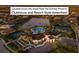 Aerial of community clubhouse with a pool, tennis courts, and bocce ball, across from Sunrise Preserve at 5557 Long Shore Loop, Sarasota, FL 34238