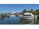 Boat docked at the marina with clear blue skies and water views for a coastal home buyer at 5557 Long Shore Loop, Sarasota, FL 34238