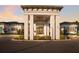Welcoming entrance to the Mattamy Homes at Tradition community center featuring grand columns and beautiful landscaping at 5557 Long Shore Loop, Sarasota, FL 34238