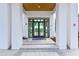 Inviting entryway to the community center featuring tile flooring, columns, and double glass doors at Mattamy Homes at Tradition at 5557 Long Shore Loop, Sarasota, FL 34238
