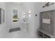Welcoming entryway with a stylish console table, coat rack, and marble flooring at 5557 Long Shore Loop, Sarasota, FL 34238