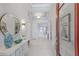 Bright foyer with marble floors, decorative mirror, tray ceiling, and views throughout the home at 5557 Long Shore Loop, Sarasota, FL 34238