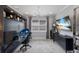 Comfortable home office with a built-in desk and shelving unit, a window, and a modern chandelier at 5557 Long Shore Loop, Sarasota, FL 34238