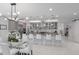 Bright kitchen features an island with seating, modern appliances, and a stylish lighting fixture over a glass-top table at 5557 Long Shore Loop, Sarasota, FL 34238