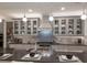 Beautiful kitchen features gray cabinets, a large center island with seating, and stainless steel appliances at 5557 Long Shore Loop, Sarasota, FL 34238