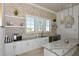 Entertain guests at this lovely kitchenette featuring modern finishes, stone countertops, and ample storage space at 5557 Long Shore Loop, Sarasota, FL 34238
