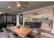 Lanai with dining table with seating, leading to kitchen and living room at 5557 Long Shore Loop, Sarasota, FL 34238