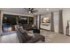 Open living room with a comfortable sectional sofa and access to the screened-in lanai and pool area at 5557 Long Shore Loop, Sarasota, FL 34238