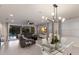Bright and airy living room with a gray sectional sofa, glass dining table, and view of the outdoor pool area at 5557 Long Shore Loop, Sarasota, FL 34238