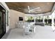This community lounge area includes a bar, television, dining table, and ample seating under large fans at 5557 Long Shore Loop, Sarasota, FL 34238