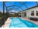 Relaxing screened-in pool area with a spa, and a covered patio, offers the perfect outdoor oasis at 5557 Long Shore Loop, Sarasota, FL 34238