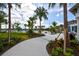 The community pool area features lush landscaping, swaying palm trees, and plenty of seating for residents to enjoy at 5557 Long Shore Loop, Sarasota, FL 34238