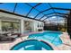 This screened-in lanai features a pool and spa, a dining area, and cozy lounge chairs for ultimate relaxation at 5557 Long Shore Loop, Sarasota, FL 34238