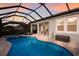 Backyard featuring a screened-in pool, spa, and covered lanai for outdoor entertaining at 5557 Long Shore Loop, Sarasota, FL 34238