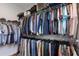 Organized walk-in closet with double hanging rods and upper shelving for maximum storage capacity and convenience at 5557 Long Shore Loop, Sarasota, FL 34238
