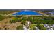 Expansive aerial view of a property with a large lake and surrounding greenery, offering a tranquil setting at 5860 Brown Ln, Sarasota, FL 34232