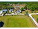 Aerial view of a home with a spacious yard, surrounded by trees and neighboring houses at 5860 Brown Ln, Sarasota, FL 34232